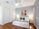 This bedroom has hardwood floors, a ceiling fan, closet space, and bedside tables at 2806 Spinning Silk Ct, Kissimmee, FL 34747