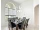 Spacious dining room featuring a modern light fixture, a large window, and seating for eight at 2806 Spinning Silk Ct, Kissimmee, FL 34747