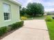 A concrete driveway leads to a charming home with lush landscaping at 2806 Spinning Silk Ct, Kissimmee, FL 34747