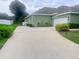 Spacious driveway leading to the home with well-maintained landscaping and a charming exterior at 2806 Spinning Silk Ct, Kissimmee, FL 34747