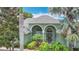 Beautiful home exterior featuring a well-manicured lawn, mature palm trees, and welcoming entryway at 2806 Spinning Silk Ct, Kissimmee, FL 34747