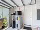 Garage with a water heater, storage, and convenient access to the house at 2806 Spinning Silk Ct, Kissimmee, FL 34747