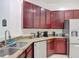 A kitchen with wooden cabinets, granite countertops, and stainless steel appliances at 2806 Spinning Silk Ct, Kissimmee, FL 34747