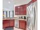 A kitchen with wooden cabinets, granite countertops, and stainless steel appliances at 2806 Spinning Silk Ct, Kissimmee, FL 34747