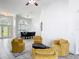 A living room with modern furniture, a rug, and a view of the dining room at 2806 Spinning Silk Ct, Kissimmee, FL 34747