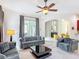 A living room with modern furniture, a rug, and a view of the patio at 2806 Spinning Silk Ct, Kissimmee, FL 34747
