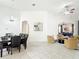 Open-concept living space with tile floors connecting the dining and living areas at 2806 Spinning Silk Ct, Kissimmee, FL 34747
