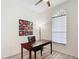This office is brightly lit by natural light and features colorful artwork on the wall at 2806 Spinning Silk Ct, Kissimmee, FL 34747