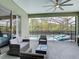 Comfortable covered patio with a ceiling fan, plus lovely views of the pool and outdoor lounge area at 2806 Spinning Silk Ct, Kissimmee, FL 34747