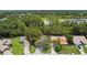 An aerial shot showcasing the property with lush greenery, mature trees, and a nearby pond at 519 Market W Sq, Lakeland, FL 33813