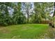 The backyard features lush greenery and mature trees, offering a private and tranquil outdoor space at 519 Market W Sq, Lakeland, FL 33813