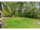 A relaxing backyard with a small playhouse nestled among mature trees and lush greenery at 519 Market W Sq, Lakeland, FL 33813