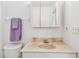 Bathroom featuring a marble-look sink, toilet, and shower, exuding a clean and functional design at 519 Market W Sq, Lakeland, FL 33813