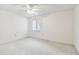 Bright bedroom with a ceiling fan, neutral carpet, and a window for natural lighting at 519 Market W Sq, Lakeland, FL 33813