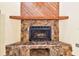 Close up on the stone fireplace featuring a wooden mantle and hearth creating a cozy ambiance at 519 Market W Sq, Lakeland, FL 33813