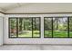 Enclosed sunroom with tile flooring and view of landscaped backyard at 519 Market W Sq, Lakeland, FL 33813