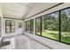 Bright sunroom with tiled floors and backyard views at 519 Market W Sq, Lakeland, FL 33813