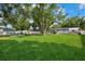 Expansive backyard features lush lawn, mature trees, and a cozy seating area at 811 Patricia Pl, Lakeland, FL 33809