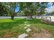 Enjoy a beautiful backyard with lush lawn, fire pit, and mature trees for outdoor living at 811 Patricia Pl, Lakeland, FL 33809
