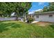 Backyard patio provides space to entertain with lush grass, plants and mature trees at 811 Patricia Pl, Lakeland, FL 33809