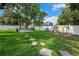 Large backyard with stepping stones, lush lawn, and a fire pit provides ample outdoor space at 811 Patricia Pl, Lakeland, FL 33809