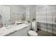 Neutral bathroom with marble countertop, modern sink, and decor with striped shower curtain at 811 Patricia Pl, Lakeland, FL 33809