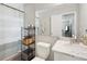 Neat bathroom featuring white fixtures, marble countertops, and a practical storage solution at 811 Patricia Pl, Lakeland, FL 33809