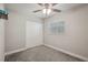 Cozy bedroom features neutral carpet, a ceiling fan, closet, and a window for natural light at 811 Patricia Pl, Lakeland, FL 33809