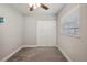 Cozy bedroom features neutral carpet, a ceiling fan, closet, and a window for natural light at 811 Patricia Pl, Lakeland, FL 33809