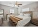 Cozy bedroom with a wooden bed frame, neutral decor, and natural light from windows at 811 Patricia Pl, Lakeland, FL 33809