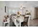 Bright dining room with a stylish white table and bench, complemented by a ceiling fan at 811 Patricia Pl, Lakeland, FL 33809