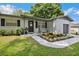 Inviting front porch with decorative plants and bench seating creates a cozy entrance at 811 Patricia Pl, Lakeland, FL 33809