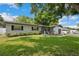 Well-maintained single-story home featuring a green lawn, landscaping, and an attached garage at 811 Patricia Pl, Lakeland, FL 33809