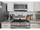 Close-up of the kitchen featuring stainless steel appliances and granite countertops at 811 Patricia Pl, Lakeland, FL 33809