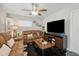 Inviting living room with leather sofas, decorative shelves, and an entertainment center at 811 Patricia Pl, Lakeland, FL 33809