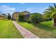 Well-maintained backyard with a brick path and lush landscaping at 1140 Terralago Way, Kissimmee, FL 34746