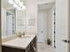 Bright bathroom with tile floor, dark vanity, framed mirror, and doorways at 1140 Terralago Way, Kissimmee, FL 34746