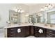 Bathroom boasts dual vanities, quartz countertops, and a large mirror at 1140 Terralago Way, Kissimmee, FL 34746