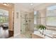 Elegant bathroom featuring a glass-enclosed shower and separate soaking tub at 1140 Terralago Way, Kissimmee, FL 34746