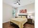 Cozy bedroom features wood floors, window with blinds, ceiling fan, and bedside tables with lamps at 1140 Terralago Way, Kissimmee, FL 34746