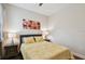Neutral bedroom with wood floor, window with blinds, flower art, bedside tables and lamps at 1140 Terralago Way, Kissimmee, FL 34746