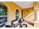 Cozy covered patio with ample seating, decorative pillars, and a brick paver floor at 1140 Terralago Way, Kissimmee, FL 34746