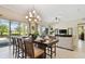Elegant dining space with a view of the screened-in lanai with palm trees and lots of natural light at 1140 Terralago Way, Kissimmee, FL 34746