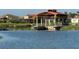 Lakefront houses with a covered boathouse on the water provide easy access for water activities at 1140 Terralago Way, Kissimmee, FL 34746