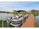 Pontoon boat is tied to a private dock with waterfront homes in the background, perfect for boating enthusiasts at 1140 Terralago Way, Kissimmee, FL 34746