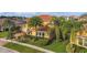 Attractive home featuring a tile roof, a paver driveway, and mature palm trees at 1140 Terralago Way, Kissimmee, FL 34746