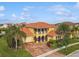 Beautiful Mediterranean-style home with a tile roof, manicured lawn, and three-car garage at 1140 Terralago Way, Kissimmee, FL 34746