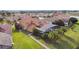 Aerial view of home with screened lanai, lush landscaping, and brick paver pathway in backyard at 1140 Terralago Way, Kissimmee, FL 34746