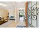 Welcoming foyer with tile flooring, a decorative rug, and a view into the living area at 1140 Terralago Way, Kissimmee, FL 34746