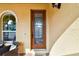 Elegant front door with decorative glass detailing, framed by an arched window at 1140 Terralago Way, Kissimmee, FL 34746